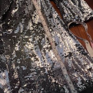 Black blazer with silver sequences. Buttons are all in tact and not itchy.